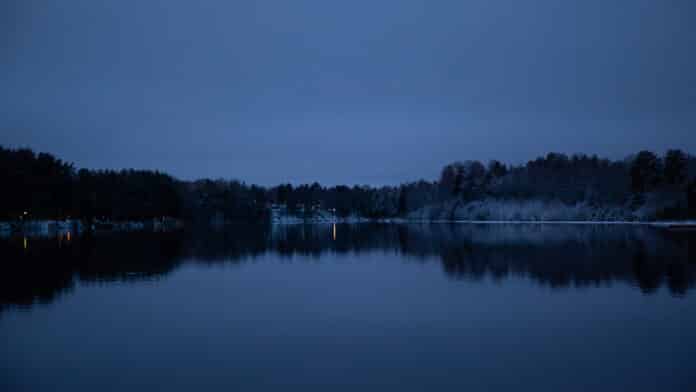 A dark winter night by the river.